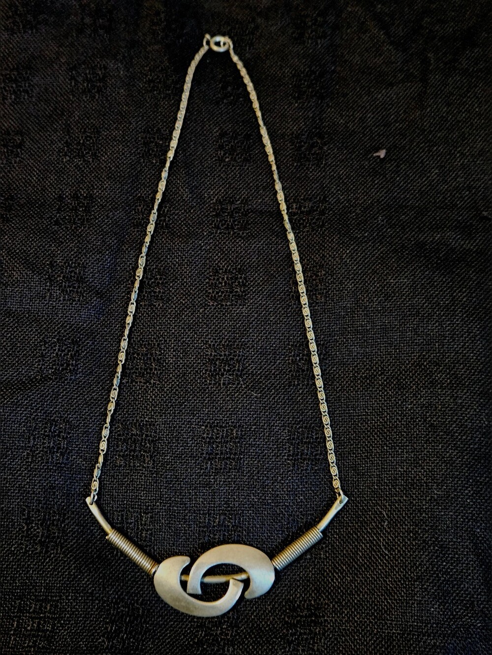Vintage- Style Abstract Logo Necklace, Silver Tone.